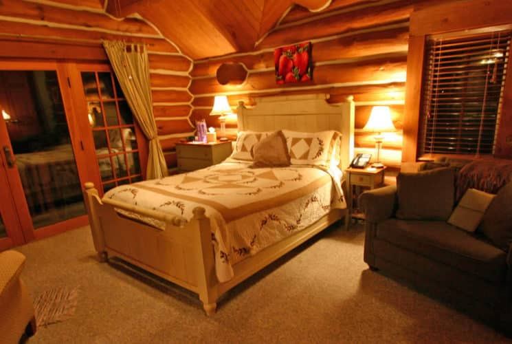 Strawberry Room at Wildberry Lodge, warm log bedroom with fireplace